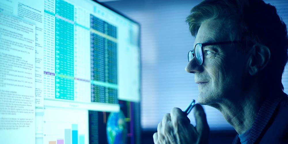 Man analyzing data on a computer screen