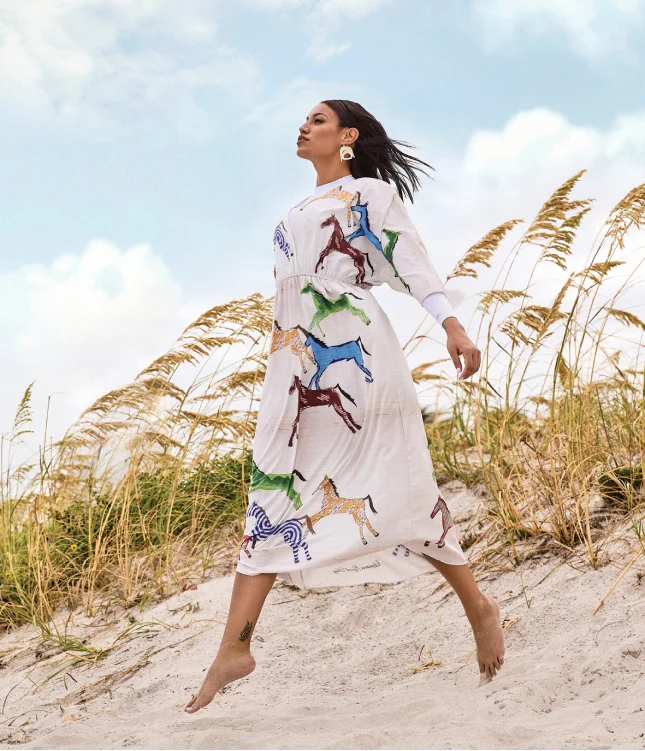 A woman posing on a beach for Fashion Magazine