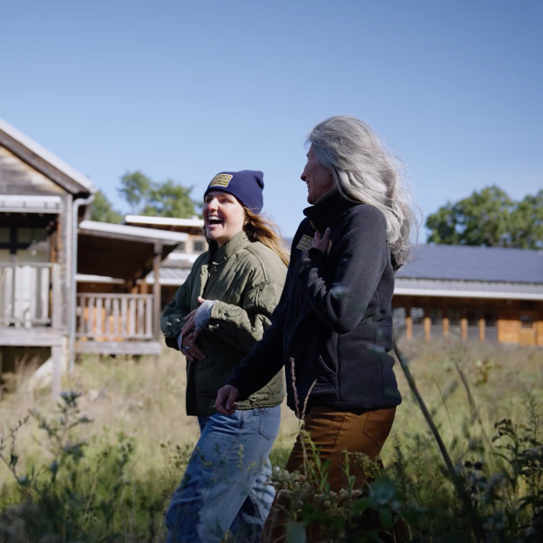 Two women walking outside and laughing