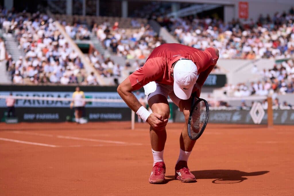 Novak Djokovic out of French Open with knee injury
