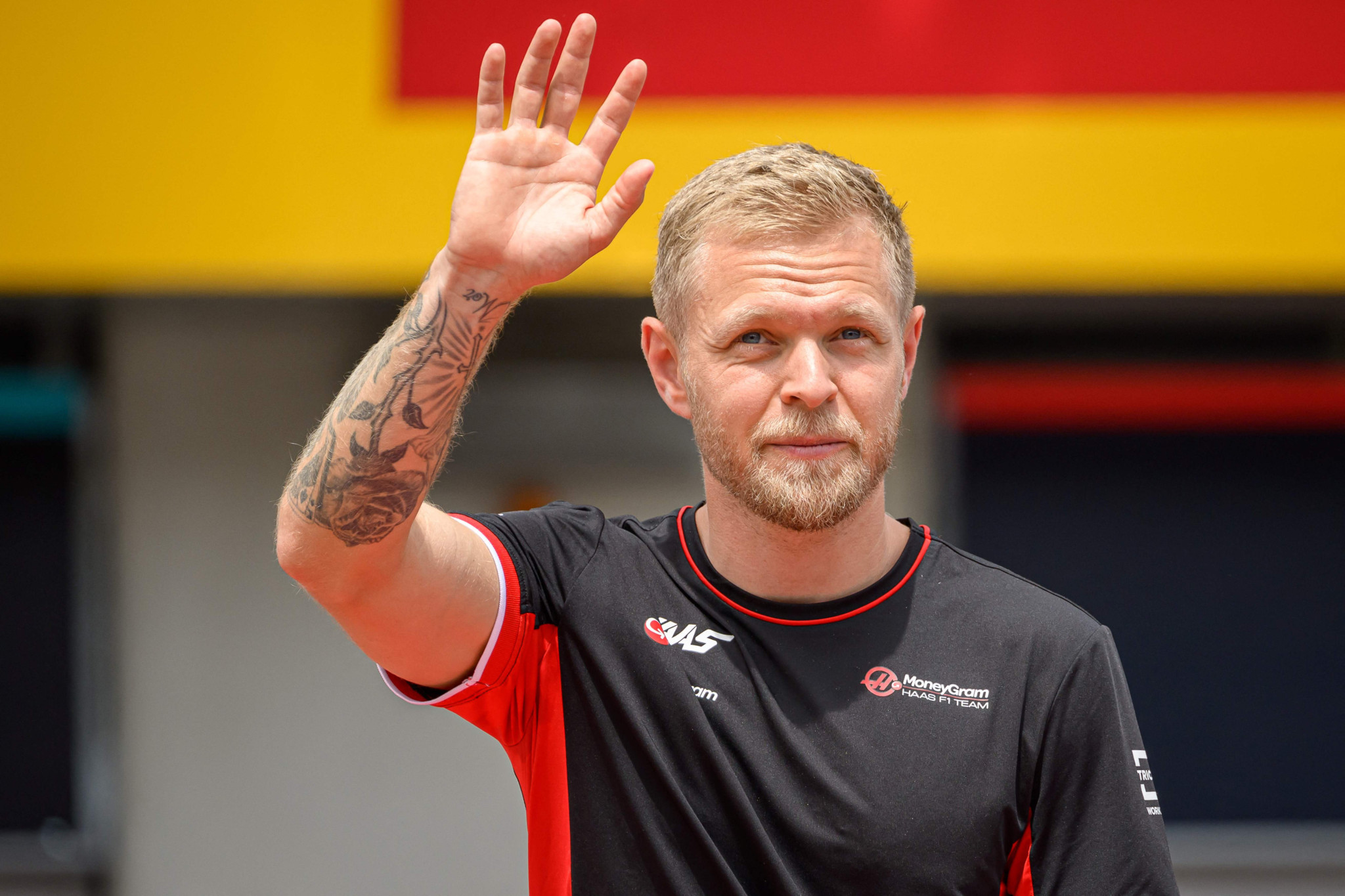 Haas F1's Danish driver Kevin Magnussen waves as he arrives to attend the Drivers Parade ahead of the Formula One Austrian Grand Prix on the Red Bull Ring race track in Spielberg, Austria, on June 30, 2024. (Photo by Jure Makovec / AFP)