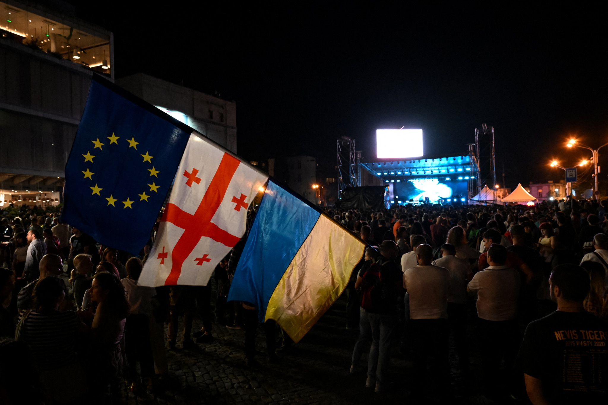 Demonstrators protesting the "foreign influence" law attend a concert aimed at raising funds to pay police fines of their fellow protesters, at Tbilisi's Republic Square on June 2, 2024. (Photo by Vano SHLAMOV / AFP)