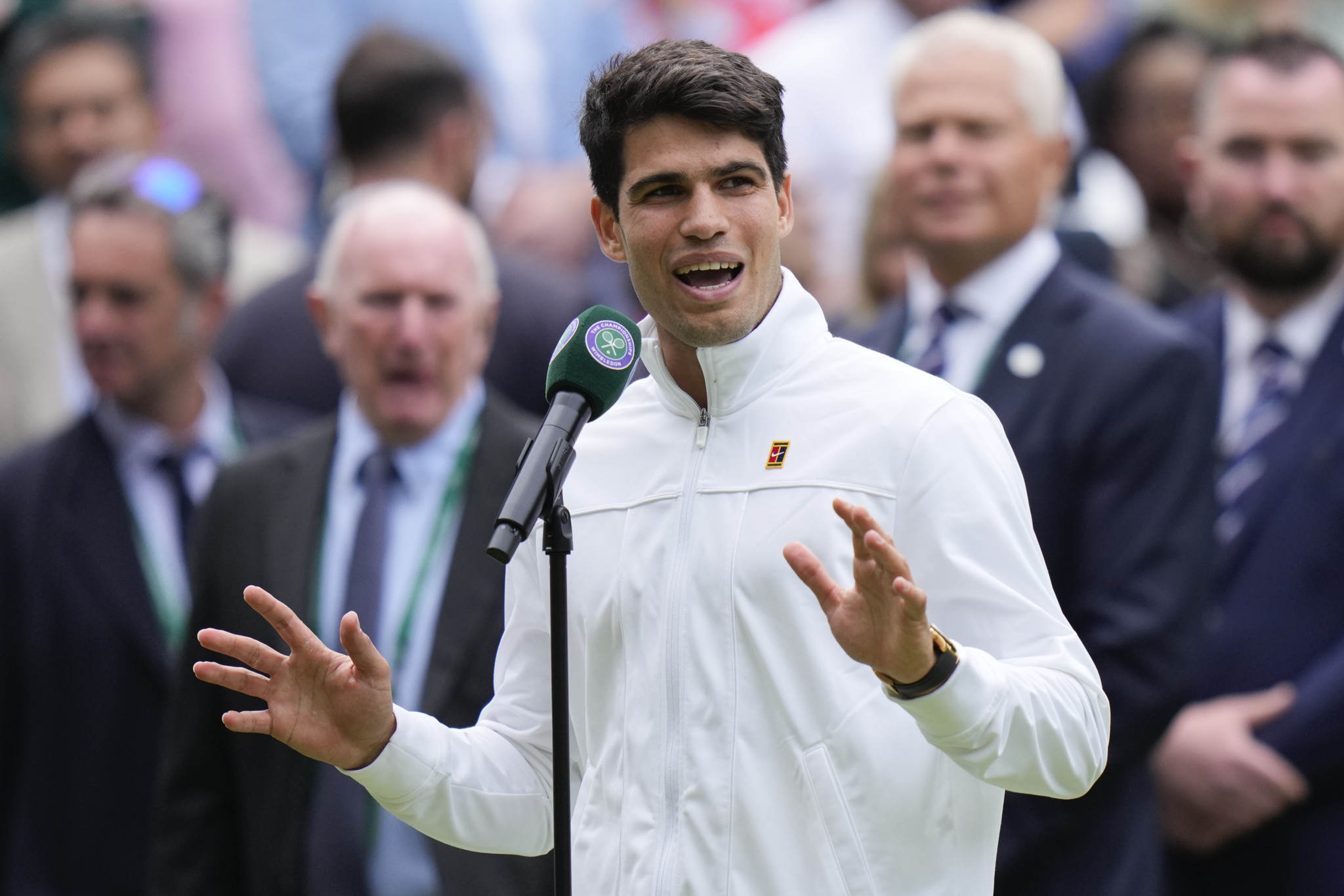 Carlos Alcaraz of Spain reacts as he is interviewed after defeating Daniil Medvedev of Russia in their semifinal match at the Wimbledon tennis championships in London, Friday, July 12, 2024. (AP Photo/Alberto Pezzali)