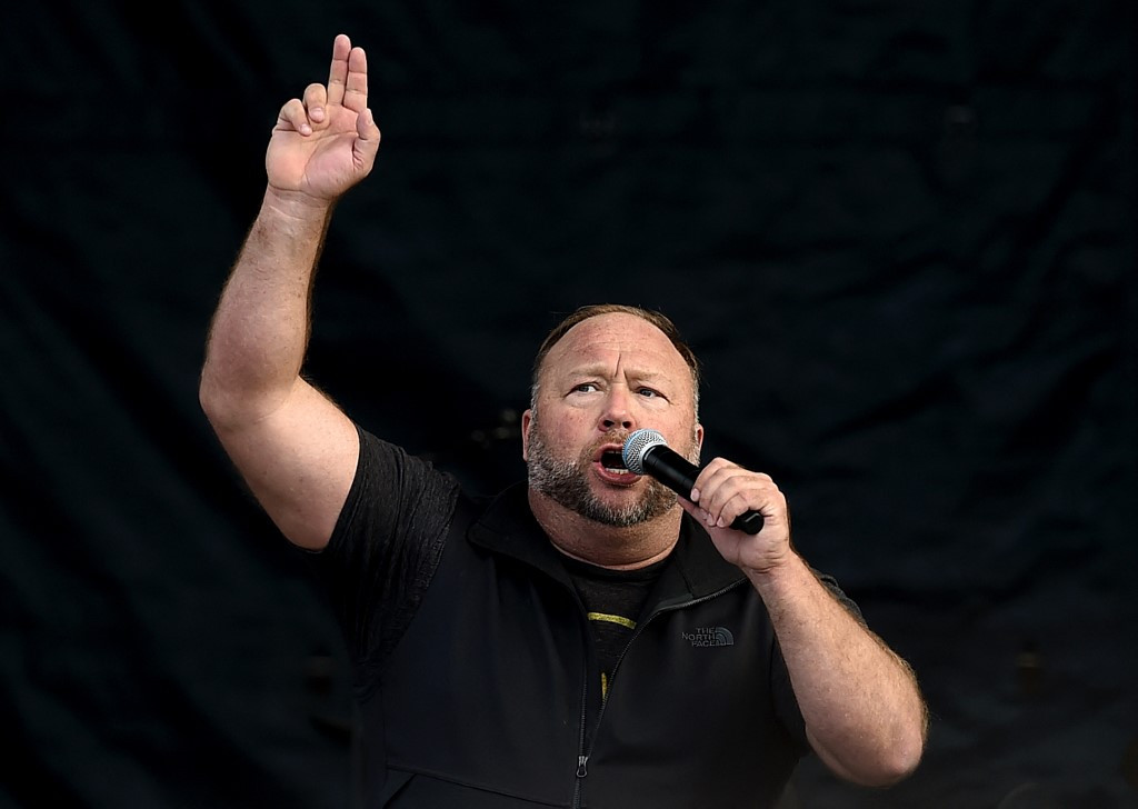 (FILES) US far-right radio show Alex Jones speaks to supporters of US President Donald Trump as they demonstrate in Washington, DC, on December 12, 2020, to protest the 2020 election. A US judge on June 14, 2024, approved the liquidation of conspiracy theorist Alex Jones' personal assets to help repay the nearly $1.5 billion in damages he owes the families of a mass shooting at a Connecticut school, media reported. (Photo by Olivier DOULIERY / AFP)