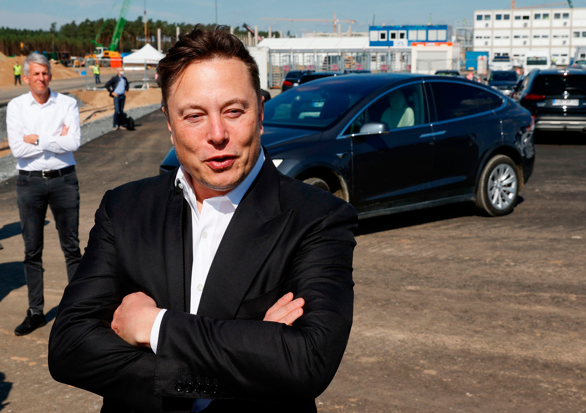 Tesla CEO Elon Musk talks to media as he arrives to visit the construction site of the future US electric car giant Tesla, on September 03, 2020 in Gruenheide near Berlin. - Tesla builds a compound at the site in Gruenheide in Brandenburg for its first European "Gigafactory" near Berlin. (Photo by Odd ANDERSEN / AFP)