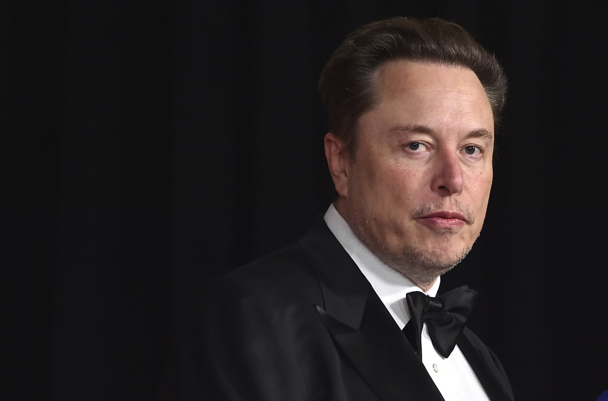 FILE - Elon Musk arrives at an event in Los Angeles, April 13, 2024. The Tesla CEO announced Wednesday, July 24, 2024, that the company's plans to build an electric car plant in northern Mexico are on hold. (Photo by Jordan Strauss/Invision/AP, File).Elon Musk