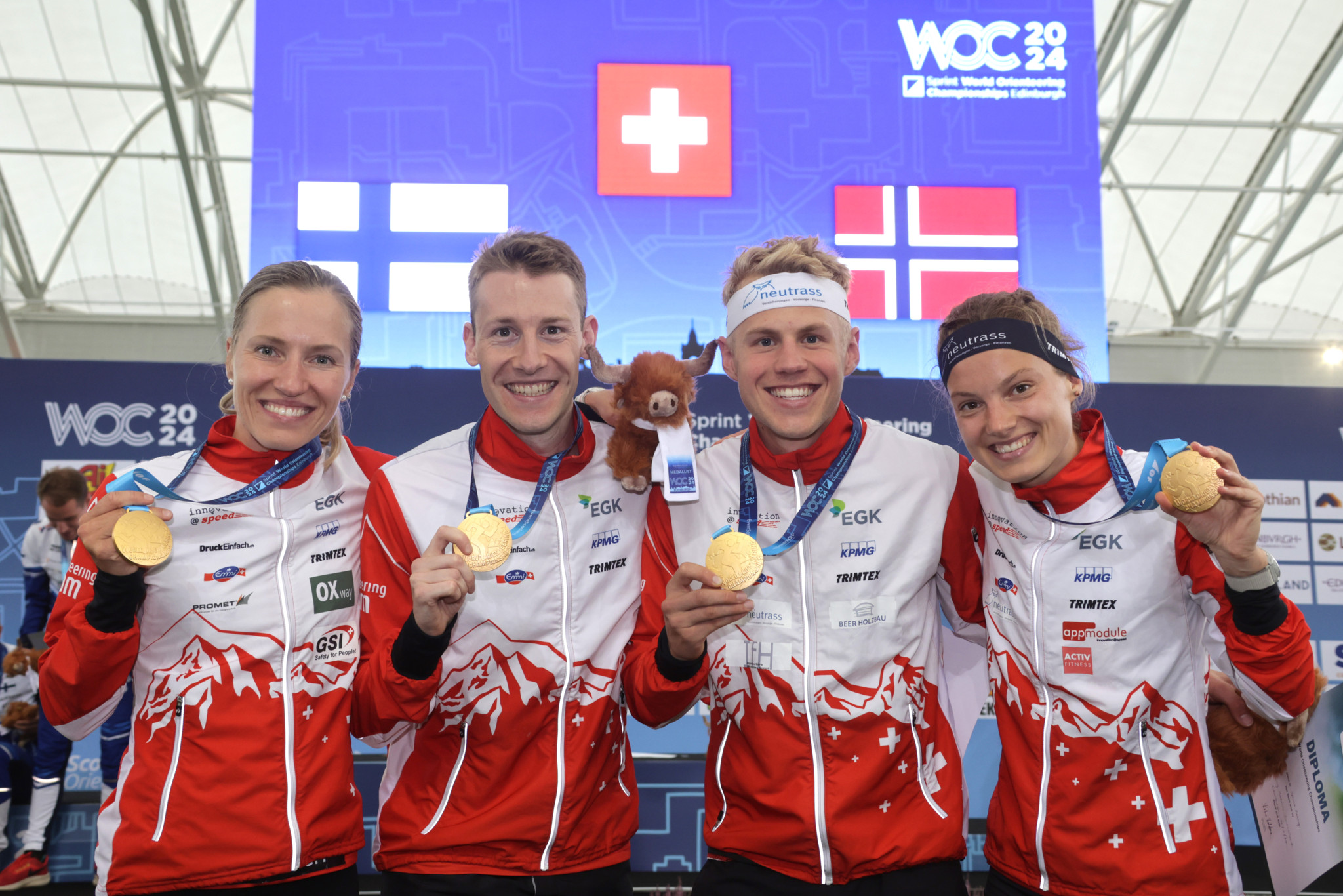 HANDOUT - EDINBURGH/SCOTLAND/UK, 14.07.2024 - Gold in Sprint Relay for Switzerland with FLTR Natalia Gemperle, Riccardo Rancan, Joey Hadorn and Simona Aebersold. Captured at the finish of the Sprint Relay at the World Orienteering Championships 2024 in Riccarton Campus, Edinburgh, Scotland. (swiss orienteering/Remy Steinegger) *** NO SALES, DARF NUR MIT VOLLSTAENDIGER QUELLENANGABE VERWENDET WERDEN ***