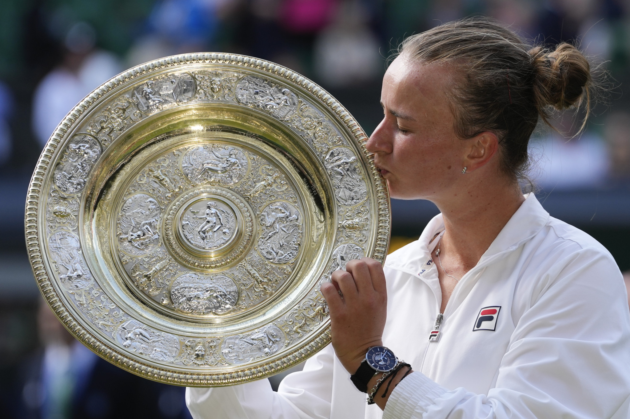 Barbora Krejcikova of the Czech Republic kisses her trophy after defeating Jasmine Paolini of Italy in the women's singles final at the Wimbledon tennis championships in London, Saturday, July 13, 2024. (AP Photo/Kirsty Wigglesworth)