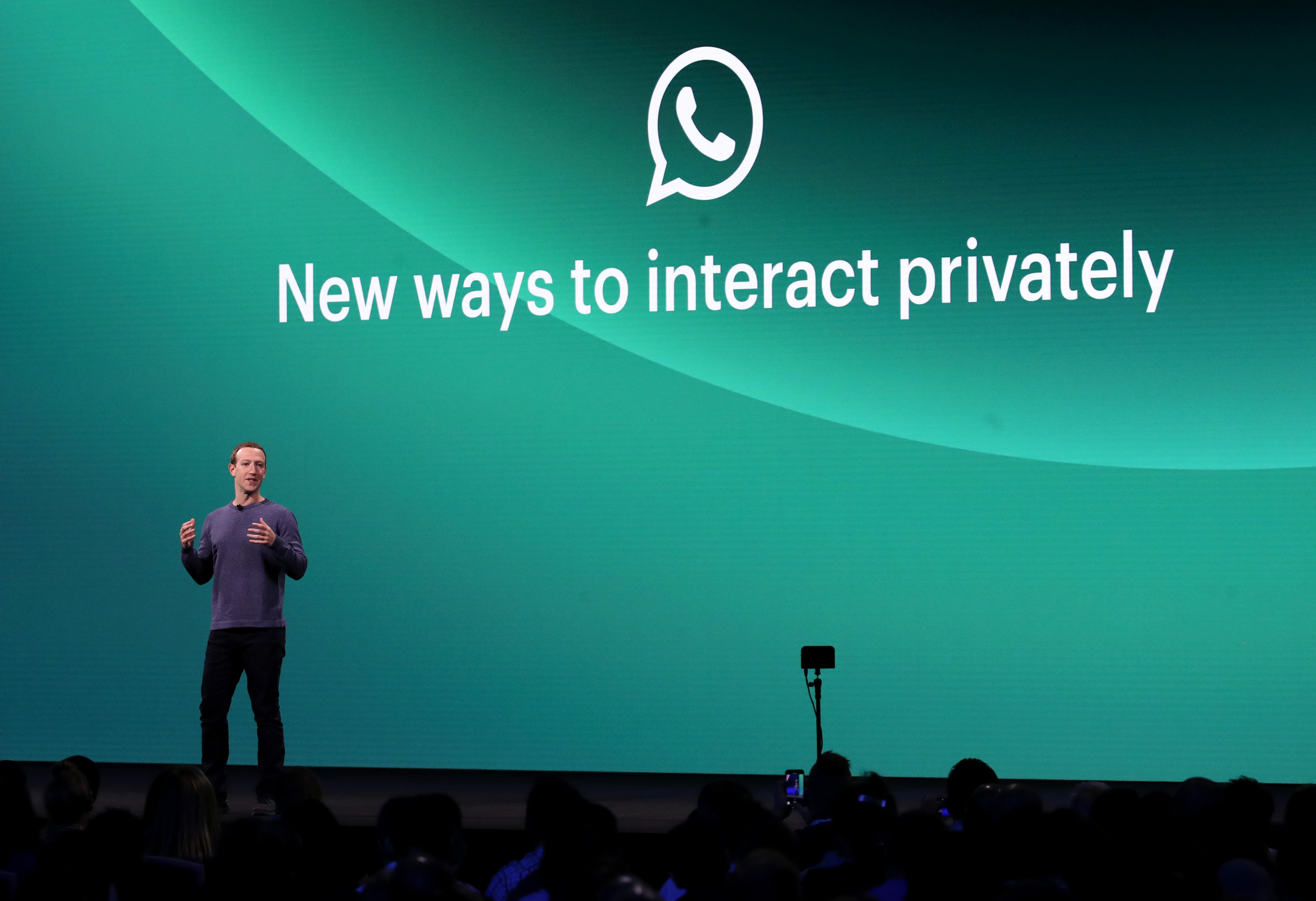 Facebook CEO Mark Zuckerberg at Facebook’s F8 developer conference standing onstage in front of a screen reading, “New ways to interact privately.”