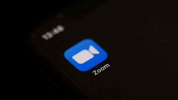 This illustration picture taken on May 27, 2020 in Paris shows the logo of the social network  application Zoom on the screen of a phone.  - Sputnik International