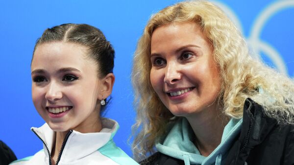 2022 Beijing Olympics - Figure Skating - Team Event - Women Single Skating - Short Program - Capital Indoor Stadium, Beijing, China - February 6, 2022.  Kamila Valieva of the Russian Olympic Committee reacts with coach Eteri Tutberidze after competing. - Sputnik International