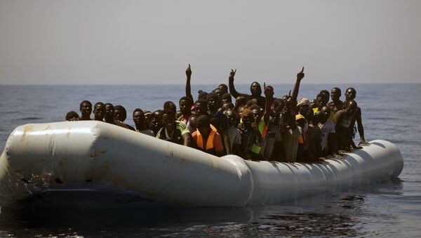 Migrants and refugees call out to Spanish NGO Proactiva Open Arms workers, after being located out of control sailing on a rubber boat in the Mediterranean Sea, about 18 miles north of Sabratha, Libya - Sputnik International