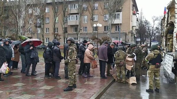 Жители Мелитополя стоят в очереди за получением гуманитарной помощи. Кадр видео