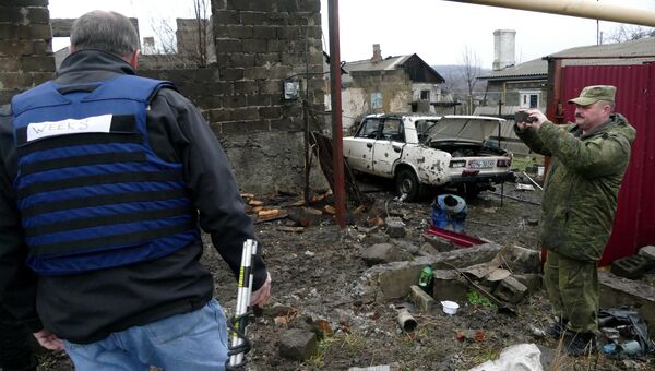 Мужчины на территории жилого дома, поврежденной в результате обстрела украинскими силовиками, в Макеевке