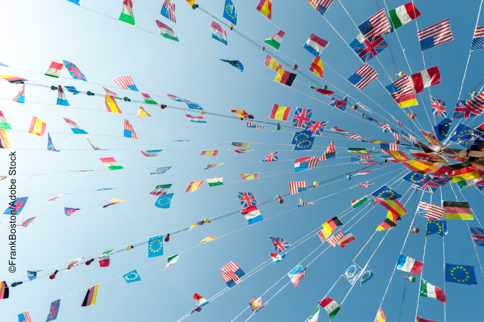 Flags from countries around the world under a blue sky