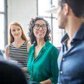 Descriptive image of smiling workers to represent our services in custom research and consulting that helps organizations answer the question, why work in the public sector?