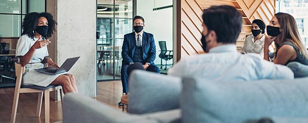 A group of employees social distanced wearing masks