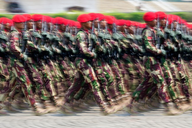 Soldiers march during a parade marking the 78th anniversary of the Indonesian Armed Forces in Jakarta on October 5, 2023. Indonesian journalist Sempurna Pasaribu and three family members died in a house fire days after Pasaribu published reports alleging high-level military involvement in an illegal gambling operation. (AP Photo/Tatan Syuflana)