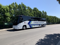 SPAB Motor Coach waiting to load students for a field trip at a school site