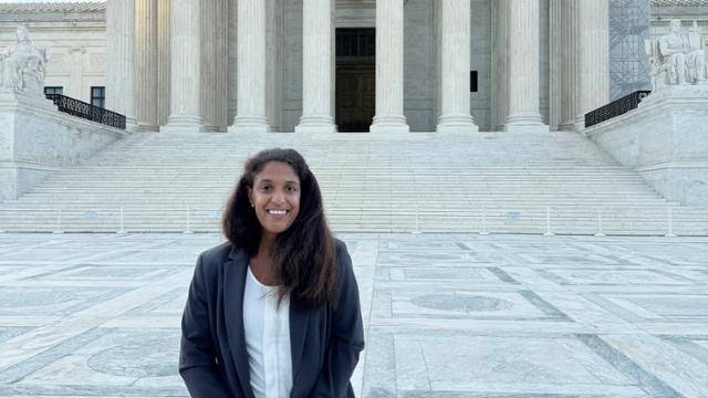 Jessica Bigby standing in front of the steps to the Supreme Court building