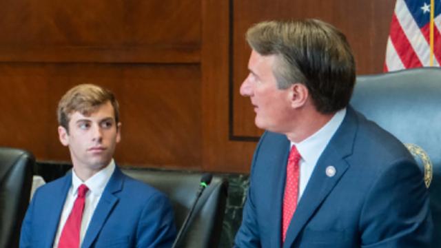 University of Richmond senior Jacob Ellis, left, listens to Virginia Gov. Glenn Youngkin during a meeting.