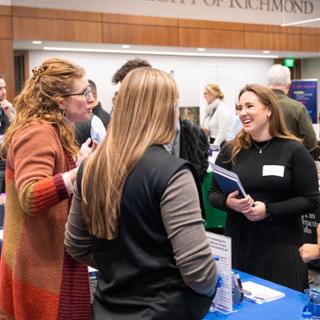 Students talking to employer