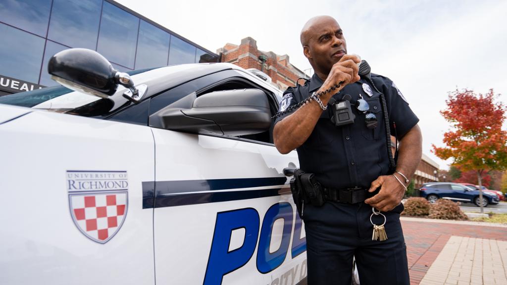 Police officer standing in front of car