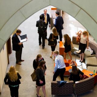 Students and faculty mill about in the lobby.