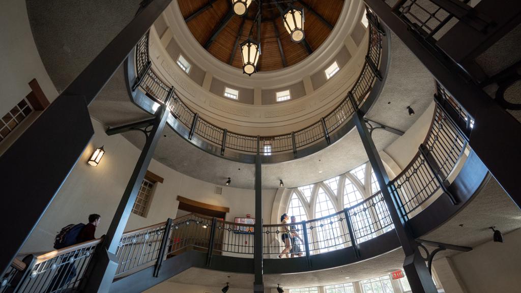 Students walking up the staircase inside Queally Tower.