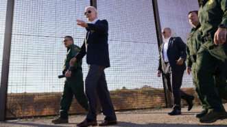 Joe Biden walking along a barrier at the U.S.-Mexico border | Photo: Andrew Harnik/Associated Press
