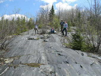 scientists on outcrop