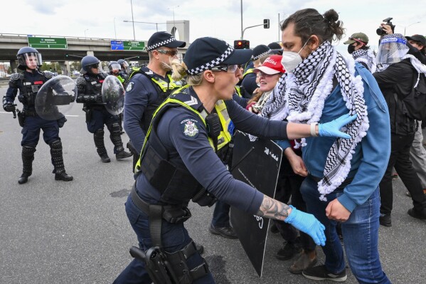 Victoria Police clash with anti-war protesters outside a military arms convention in downtown Melbourne, Australia,Wednesday, Sept. 11, 2024. (Joel Carret/AAP Image via AP)