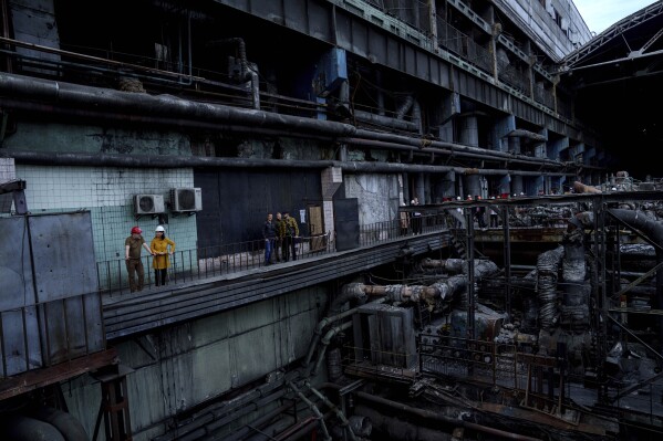 German's Foreign Minister Annalena Baerbock speaks to Ukrainian Energy Minister Herman Halushchenko during official visit to a thermal power plant which was destroyed by a Russian rocket attack in Ukraine, Tuesday, May 21, 2024. (AP Photo/Evgeniy Maloletka)