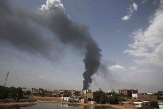 FILE - Smoke rises over Khartoum, Sudan, on June 8, 2023, as fighting between the Sudanese army and paramilitary Rapid Support Forces continues. Four Western countries have floated a proposal on Wednesday Oct. 4, 2023 for the U.N.'s top human rights body to appoint a team of experts to monitor and report on abuses and rights violations in war-wracked Sudan. (AP Photo, File)