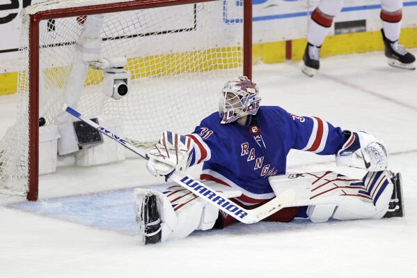 New York Rangers goaltender Igor Shesterkin looks back at the puck in the net after the Carolina Hurricanes scored in the third period during Game 5 of an NHL hockey Stanley Cup second-round playoff series Monday, May 13, 2024, in New York. (AP Photo/Adam Hunger)