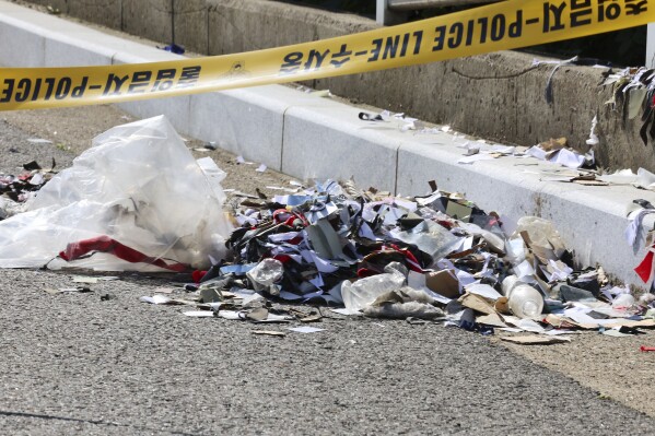 The trash from a balloon presumably sent by North Korea, is seen behind police tape in Incheon, South Korea, Sunday, June 2, 2024. North Korea launched hundreds of more trash-carrying balloons toward the South after a similar campaign a few days ago, according to South Korea’s military, in what Pyongyang calls retaliation for activists flying anti-North Korean leaflets across the border. (Im Sun-suk/Yonhap via AP)