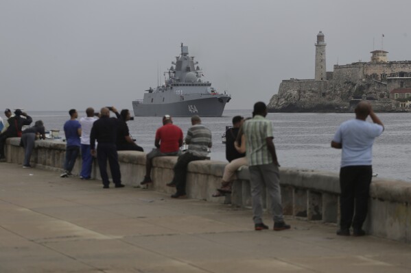 People watch the Russian Navy Admiral Gorshkov frigate arrive at the port of Havana, Cuba, Wednesday, June 12, 2024. A fleet of Russian warships reached Cuban waters on Wednesday ahead of planned military exercises in the Caribbean. (AP Photo/Ariel Ley)