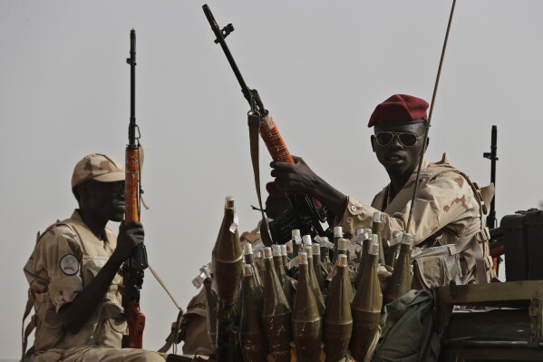 FILE - Sudanese soldiers from the Rapid Support Forces unit, led by Gen. Mohammed Hamdan Dagalo, the deputy head of the military council, secure the area where Dagalo attends a military-backed tribe's rally, in the East Nile province, Sudan, on June 22, 2019. Human rights experts working for the United Nations on Wednesday, June 26, 2024 accused Sudan’s warring parties of using starvation as a war weapon, amid mounting warnings about imminent famine in the African nation. Sudan plunged into chaos in April last year when simmering tensions between the country’s military and a notorious paramilitary group, the Rapid Support Forces, exploded into open fighting in the capital, Khartoum and elsewhere in the country. (AP Photo/Hussein Malla, File)