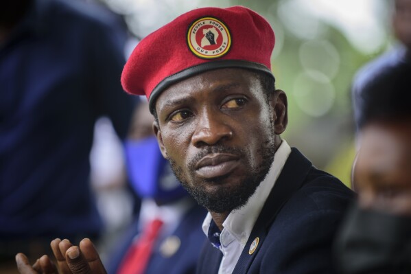 FILE - Opposition presidential challenger Bobi Wine, speaks to the media outside his home, in Magere, near Kampala, in Uganda, Jan. 26, 2021. (AP Photo/Nicholas Bamulanzeki, File)