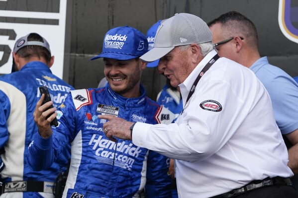 Kyle Larson, front left, walks with Rick Hendric, front right, after Larson won a NASCAR Cup Series auto race at Indianapolis Motor Speedway, Sunday, July 21, 2024, in Indianapolis. (AP Photo/Darron Cummings)