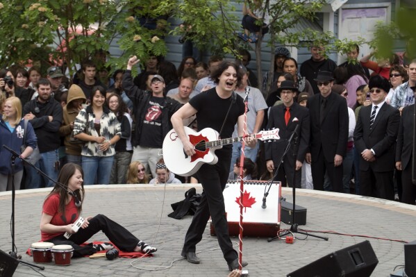 FILE - Musicians Jack White, right, and Meg White of the band The White Stripes perform an impromptu concert in Whitehorse, Yukon, Canada, June 25, 2007. (AP Photo/The Canadian Press, Vince Fedoroff, File)