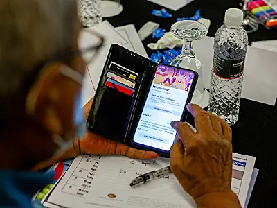 A man uses a smartphone to check out an online community sponsored by Better Health Malaysia.