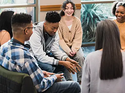 Teenagers seated in circle