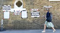 A woman walks by a polling station during the general election in London.
Pic:Reuters