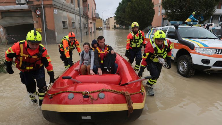 Firefighters use a dingy boat to evacuate civilians after flooding in Faenza, in the region of Emilia Romagna, Italy, Thursday, Sept. 19, 2024. (Fabrizio Zani/LaPresse via AP)