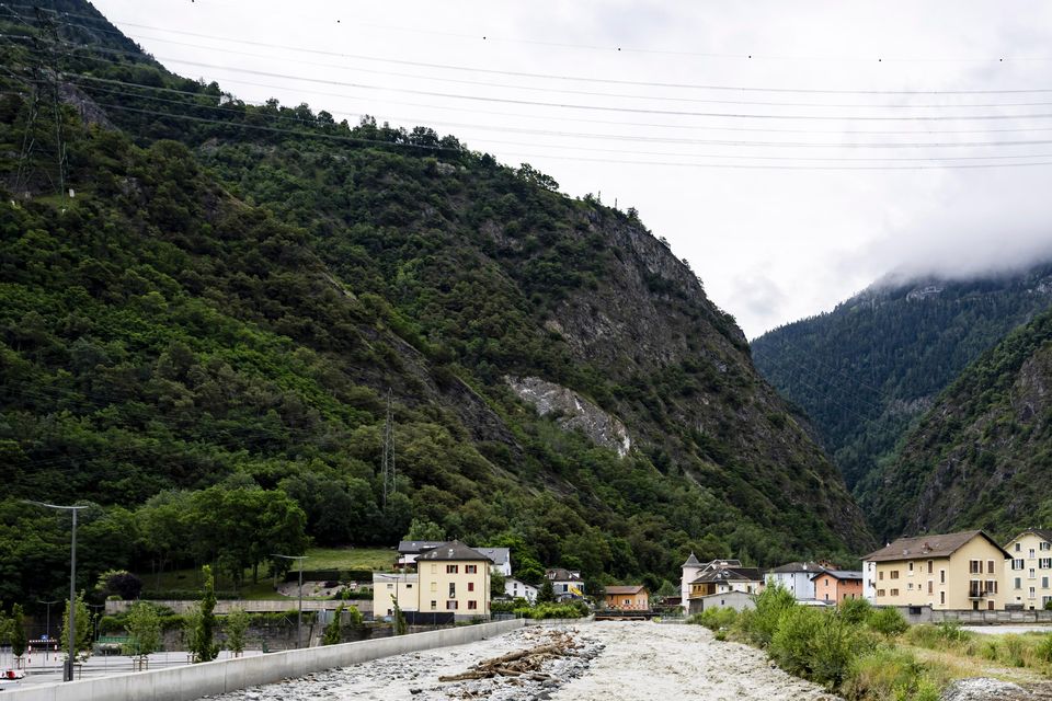 An excavator removes stones from the bed of the Navizence River, which flows into the Rhone, in Chippis, canton Valais, Switzerland (Jean-Christophe Bott/Keystone via AP)