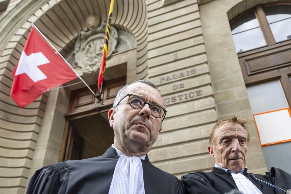 Lawyers for the Hindujas, Nicolas Jeandin, left, and Robert Assael, right, leave court (Martial Trezzini/Keystone via AP)