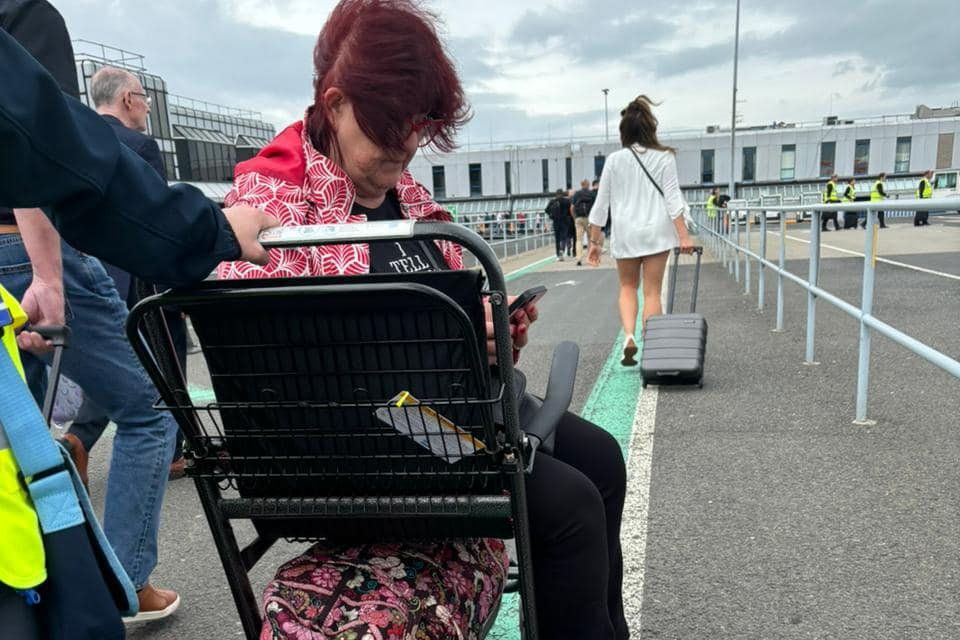 Liz Weir was left behind on the runway at Belfast International along with another wheelchair user and her husband on Friday.