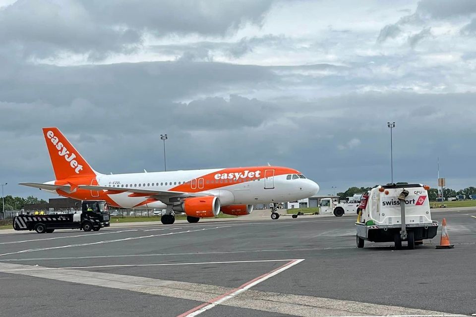 easyJet has apologised and promised to investigate why three passengers were left behind on the runway at Belfast International Airport.