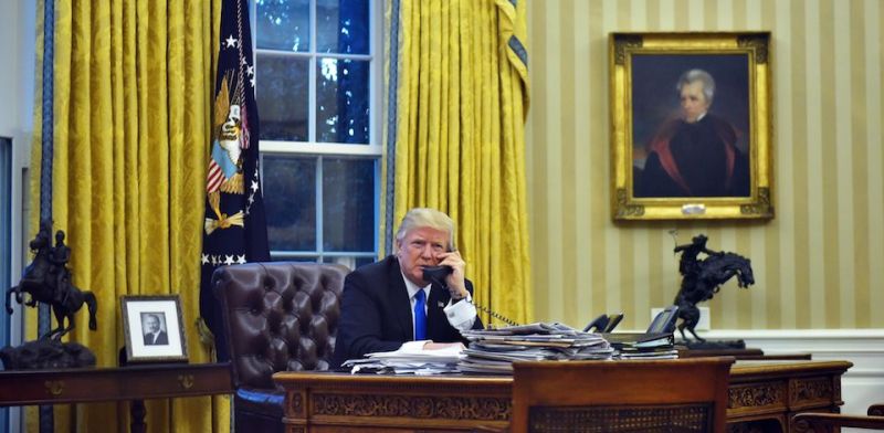 US President Donald Trump speaks on the phone with Australia's Prime Minister Malcolm Turnbull from the Oval Office of the White House on January 28, 2017, in Washington, DC. / AFP / MANDEL NGAN        (Photo credit should read MANDEL NGAN/AFP/Getty Images)